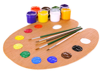 Wooden art palette with paint and brushes isolated on white