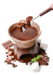 Chocolate fondue with marshmallow candies, isolated on white