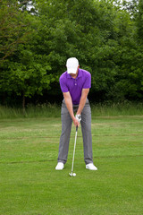 Golfer playing a mid iron shot