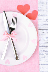 Romantic holiday table setting, on wooden background