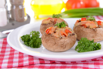 Stuffed mushrooms on plate on table close-up