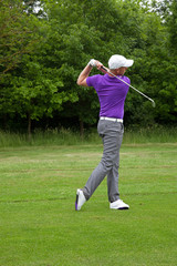 Golfer playing a mid iron shot