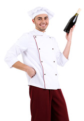 Professional chef in white uniform and hat,holding bottle of