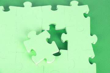 Last piece of jigsaw puzzle, close-up, on blue background
