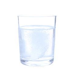 Glass with efervescent tablet in water with bubbles isolated