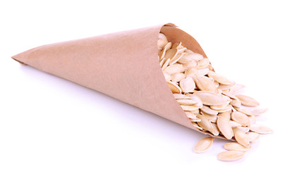 Pumpkin seeds in paper cornet isolated on white
