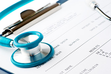 Blood test results in a clipboard with stethoscope