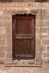 ancient wooden door in stone wall