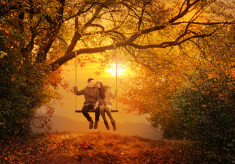 Obraz na płótnie Canvas Romantic couple swing in the autumn park