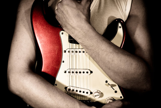 Man Holding His Red Guitar