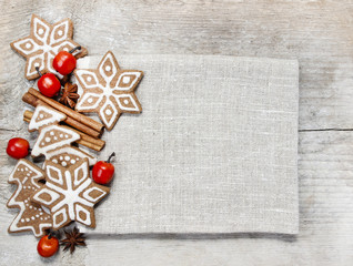 Gingerbread cookies, dried fruits and small apples on wood