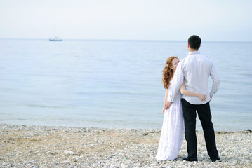 beautiful young couple in love near the sea