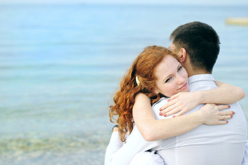 beautiful young couple in love near the sea