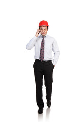 man engineer in a red helmet talking on the phone