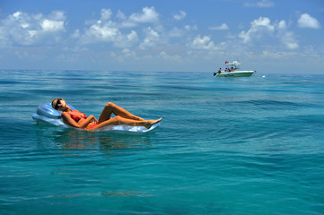 Woman in red bikini on floating device