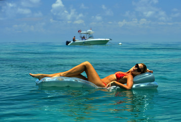 Woman in red bikini on floating device