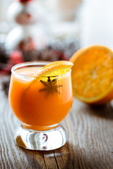 Fresh orange juice with orange slice and anise