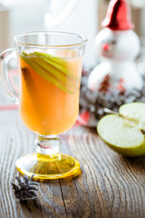 Fresh apple juice with  apple slices and cinnamon stick