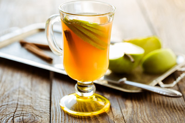 Fresh apple juice with  apple slices and cinnamon stick