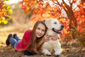 Beautiful woman and her dog posing in autumn park