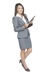 Young pretty Asian business woman gesture using a tablet smiling