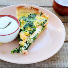 piece of quiche with salmon and spinach