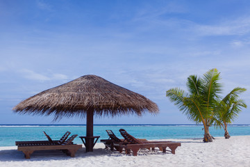 Fototapeta premium Relaxing chairs in front of the Indian Ocean in Maldive Islands