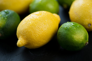 Ripe limes and lemons, close-up, horizontal shot