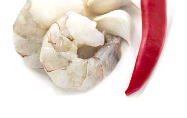 Raw Shrimp on white plate with red chili pepper