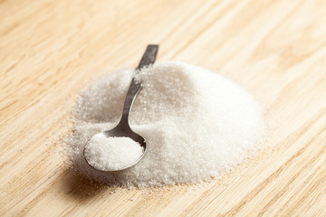 Fototapeta na wymiar Spoon in a pile of sugar