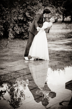 bride and groom outdoors after rain
