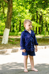 Handsome barefoot little boy standing waiting