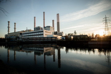Fototapeta na wymiar Electricity power plant near a river