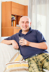Relaxed man sitting on couch