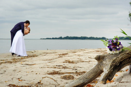 bride and groom on the beach, a wedding bouquet, wedding dresses