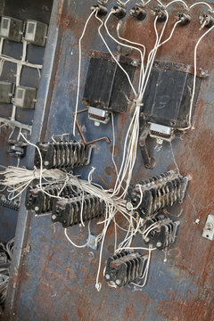 Old rusty electric transformer box with wires