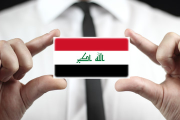 Businessman holding a business card with Iraq Flag