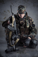 soldier sitting on the floor with arms