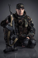 soldier sitting on the floor with arms