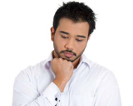 Young, sad man deep in thought, troubled by bad news