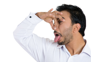 Man pinches his nose, something stinks, very bad smell