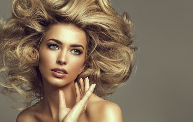 Portrait of a young blond woman with beautiful hair and green ey
