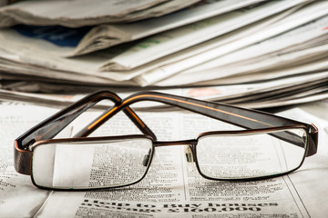 Glasses on newspaper