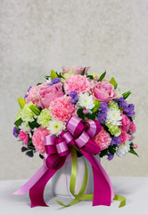 Flower bouquet in white ceramic pot