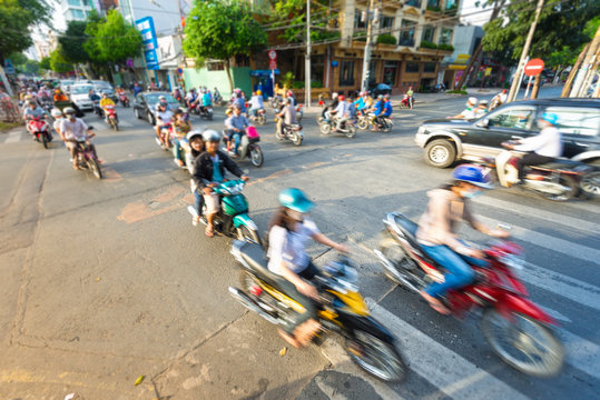 Stream of bikes in busy street in Vietnam.