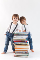 Two boys on a pile of books