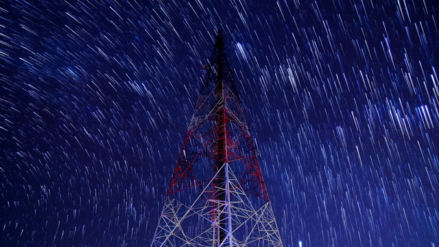 time lapse communication tower and startrail in the night sky