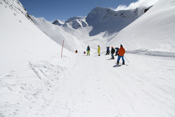 Fototapeta na wymiar Skiers going down the slope at ski resort