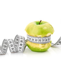 white measuring tape and apple