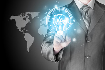 Business man touching light of idea